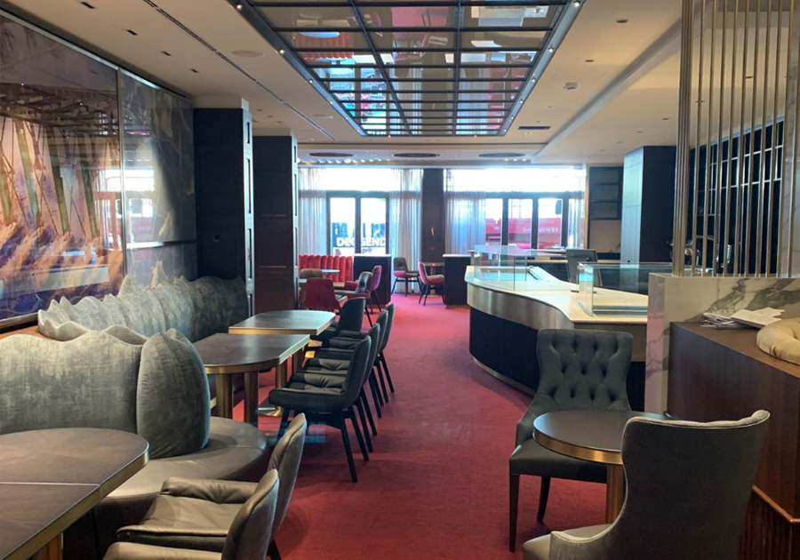 Langer Raum mit Sitzreihe, Spiegeldecke und Tageslicht im Kaffeehaus Deggendorf.